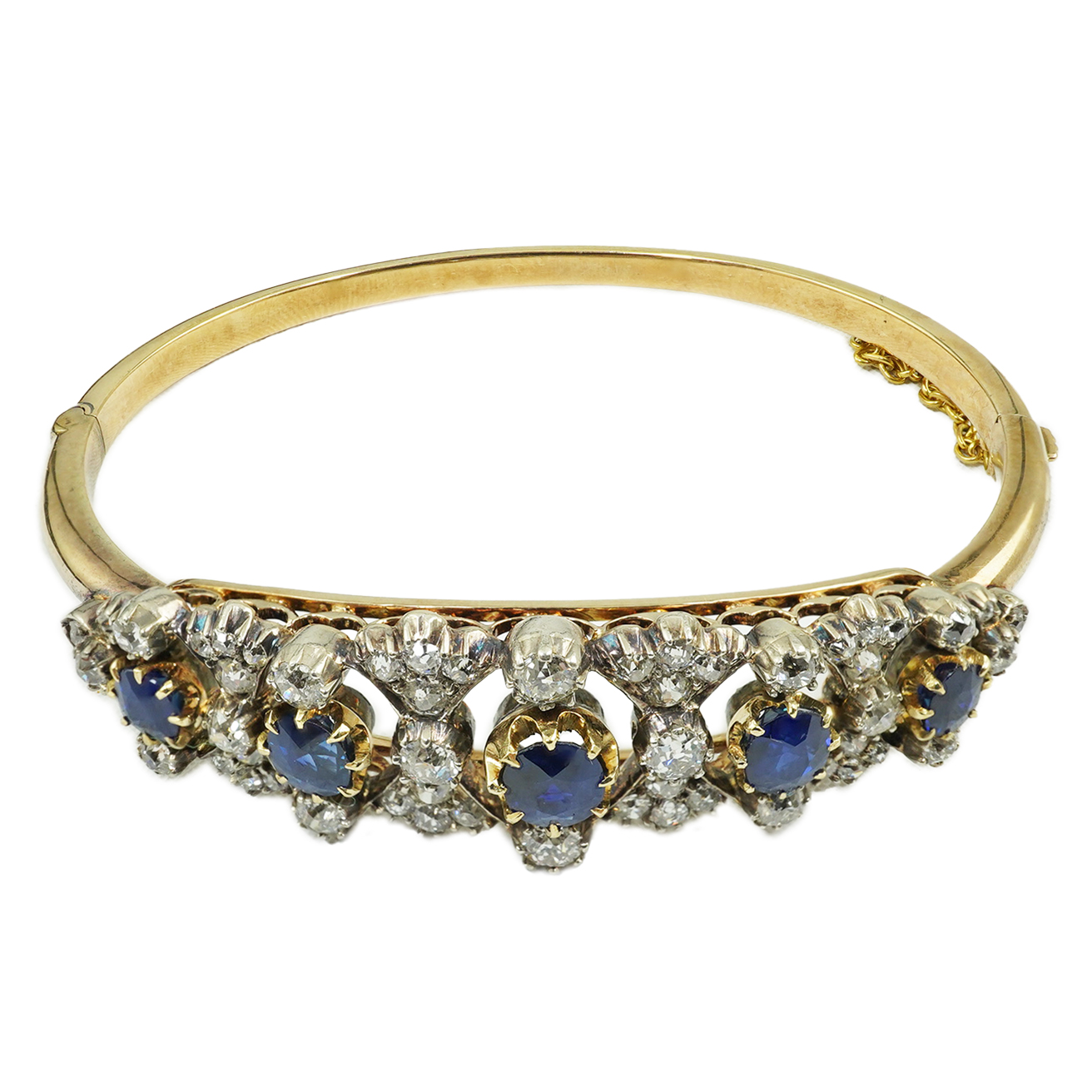 A late Victorian gold, sapphire and diamond cluster hinged bangle